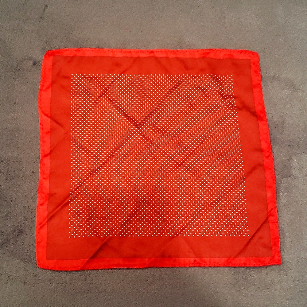 One red pocket square with white dot pattern.